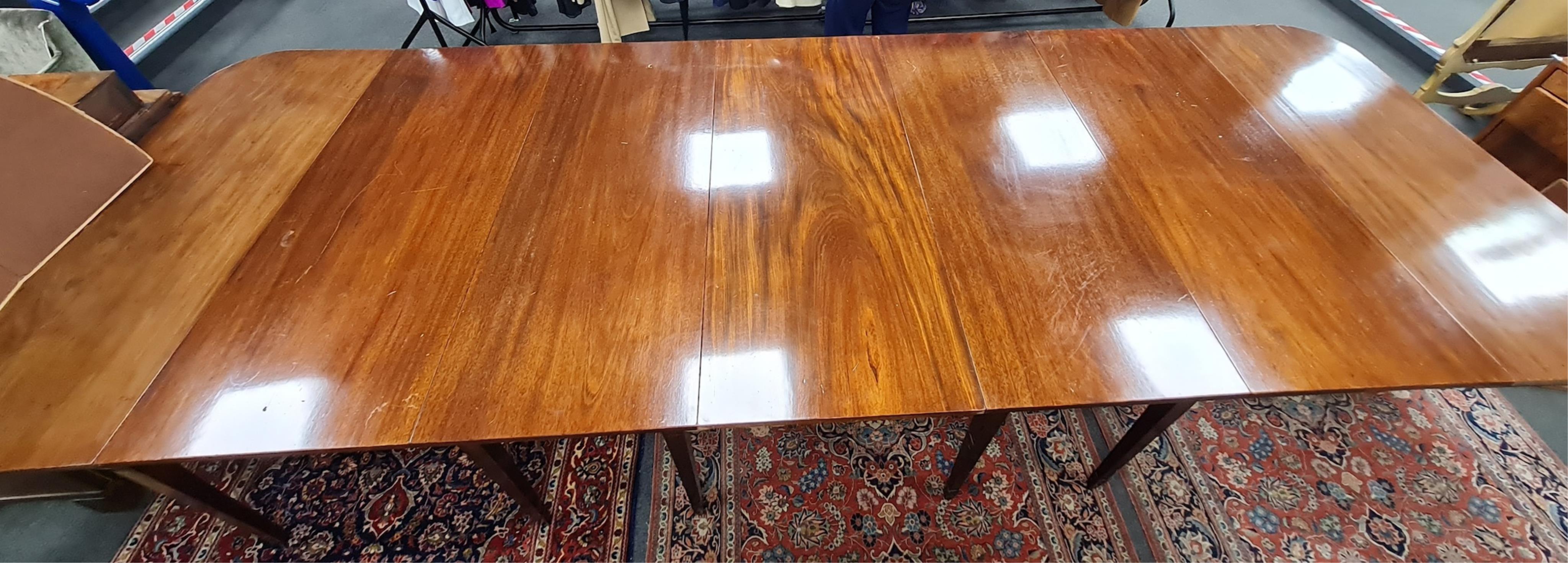 A George III mahogany extending dining table, width 396cm extended, depth 137cm, height 74cm. Condition - fair